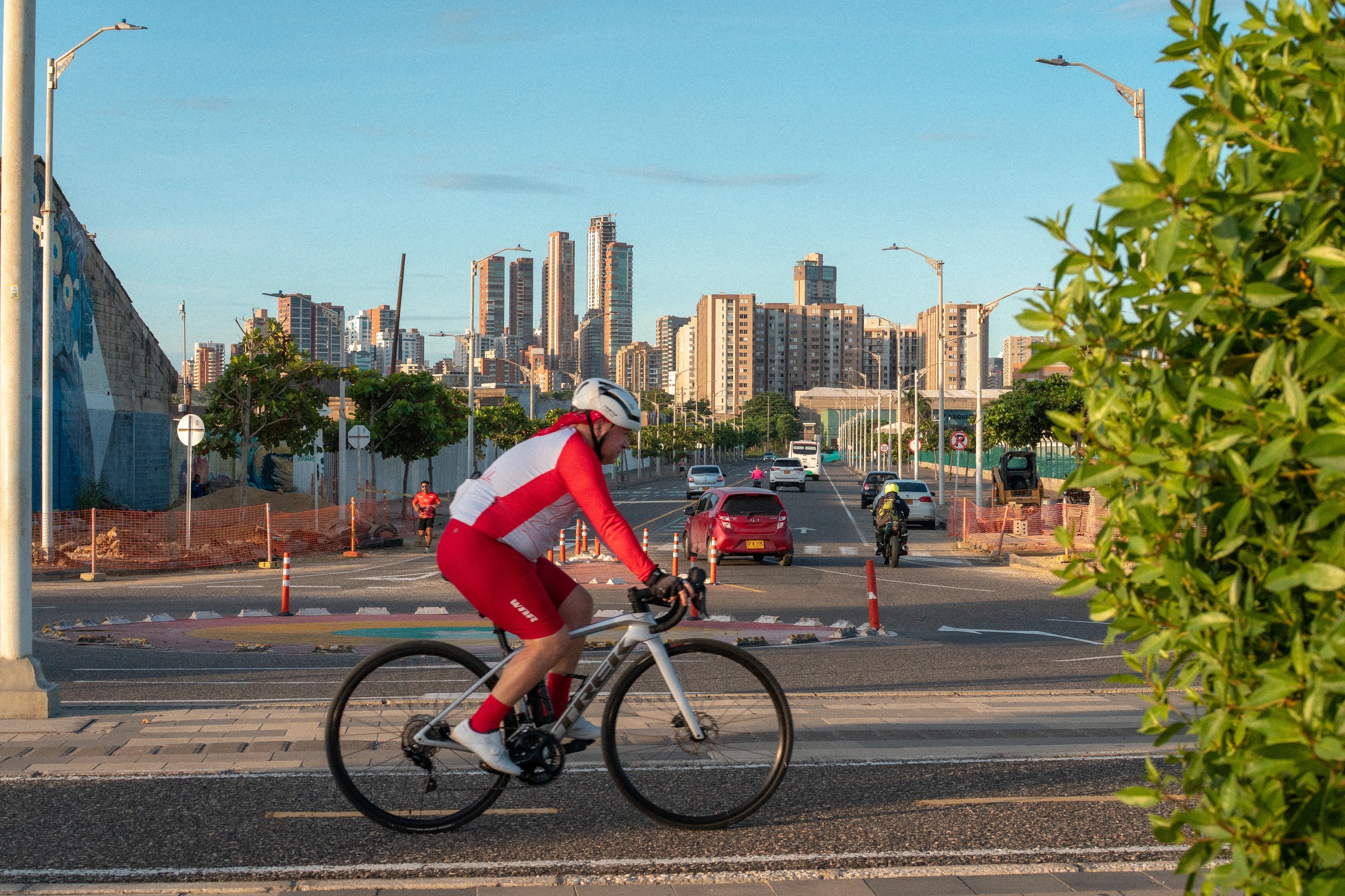 A cyclist crossing a city promenade