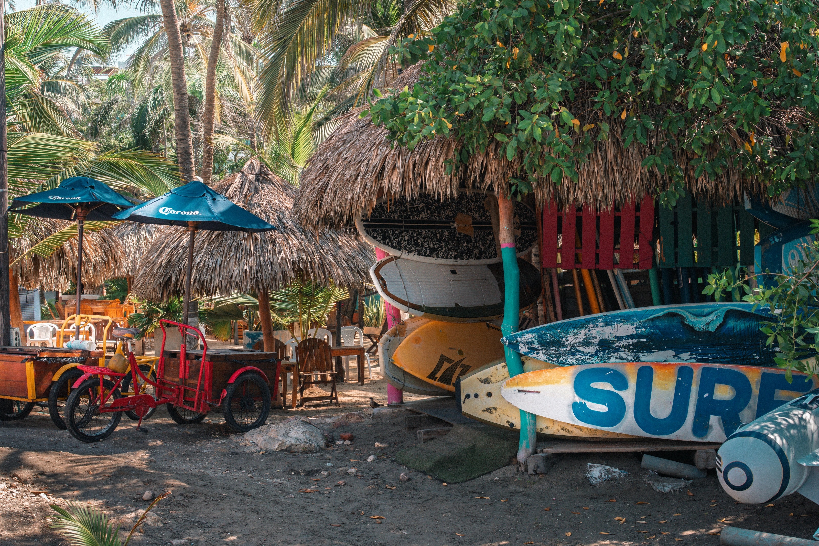 Bicycles and surfboards outside a beachside shop