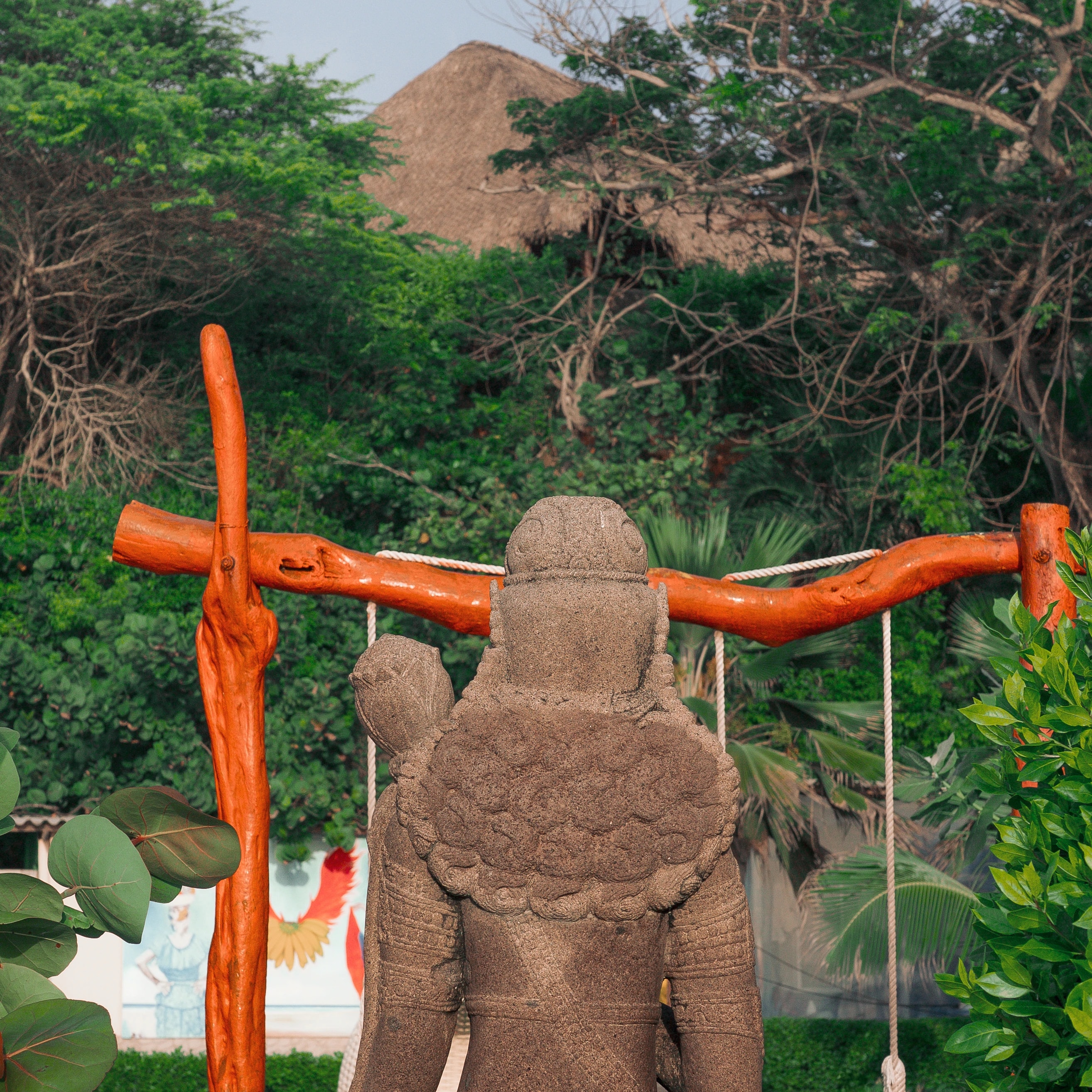 A stone figure and an orange wooden frame