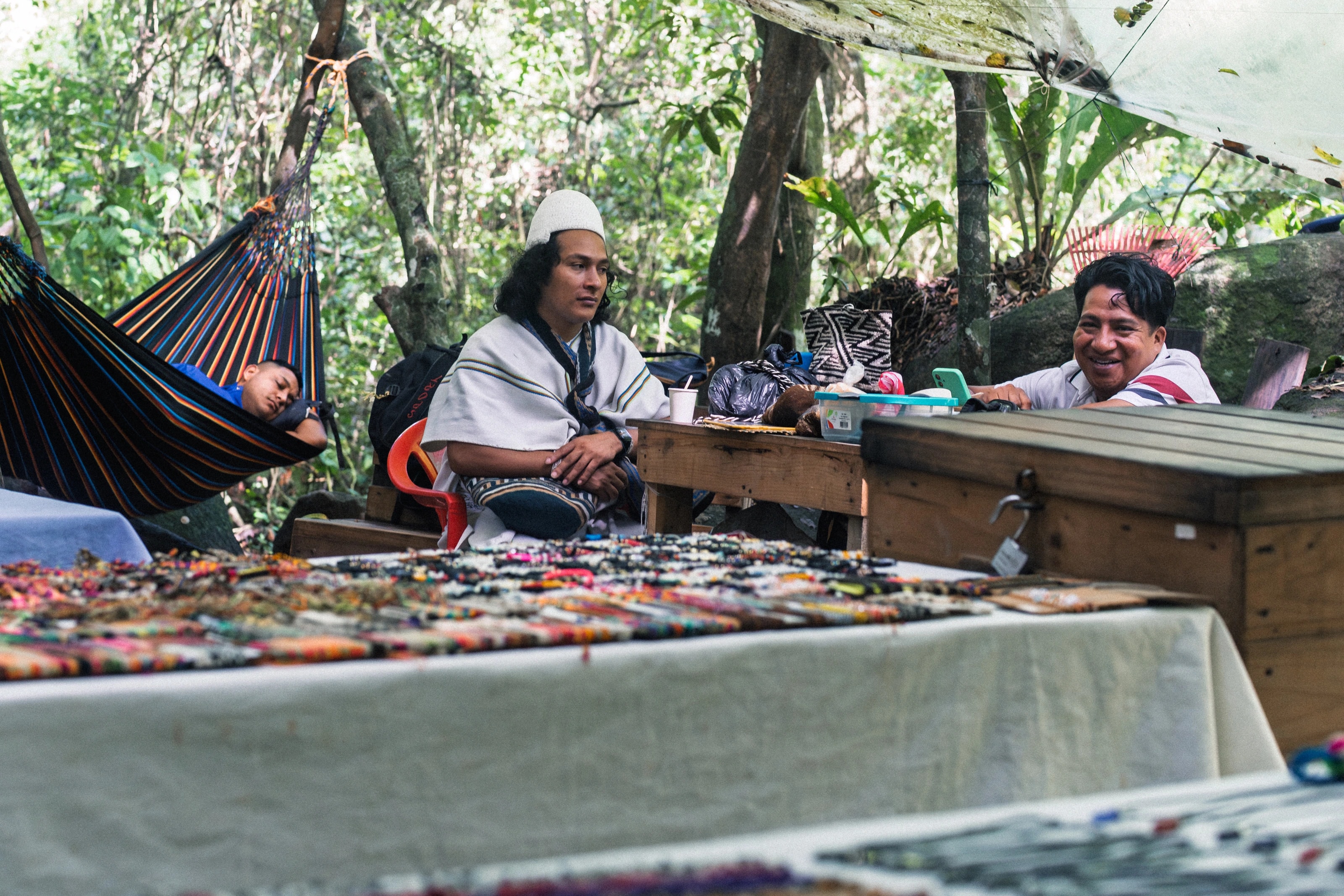People at a table in a tropical garden